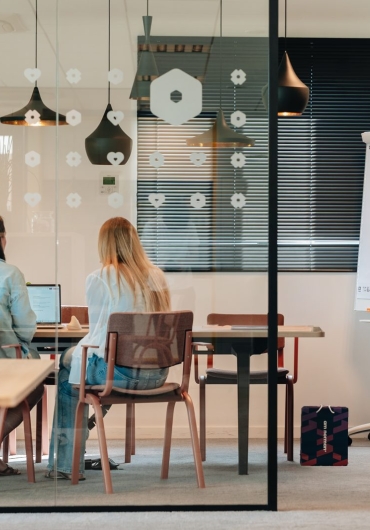AMNorman colleagues in a meeting room with a flipchart